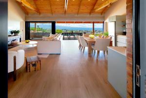 a kitchen and living room with a table and chairs at StonenSea in Plettenberg Bay