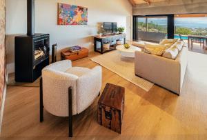 a living room with a couch and a fireplace at StonenSea in Plettenberg Bay