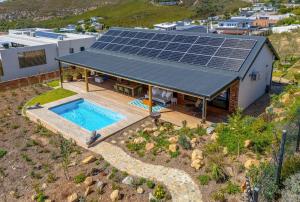 an overhead view of a house with solar panels on the roof at StonenSea in Plettenberg Bay