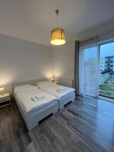 a bedroom with a bed and a large window at db Home - Near Brasov City Center in Ghimbav