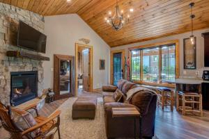 a living room with a couch and a fireplace at Banner View in Banner Elk