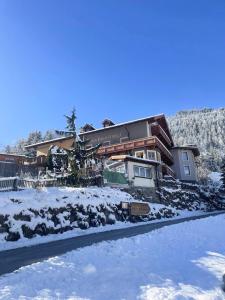 a house in the winter with snow on the ground at Apartment Klapo in Bad Gastein