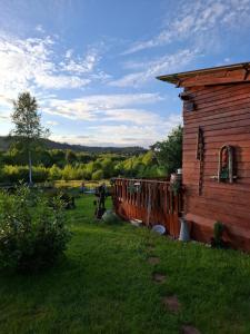a log cabin in a field next to a house at La Cabane du Trappeur in La Bourgonce +16 photos