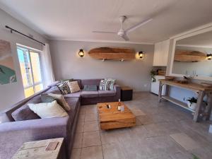 a living room with a couch and a coffee table at Unit 40 Chakas Rock Chalets in Ballito