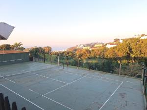 a tennis court with a tennis racket on it at Unit 40 Chakas Rock Chalets in Ballito