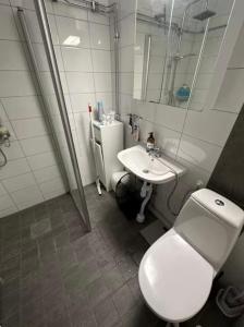 a bathroom with a toilet and a sink at Wesfield Private in Solna