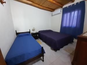 En eller flere senge i et værelse på Cabaña DOÑA LILIA