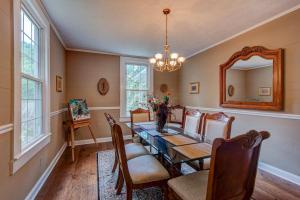 a dining room with a table and chairs and a mirror at Historic McGuire House in Todd