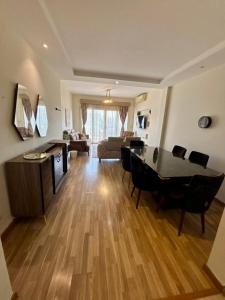 a living room with a table and chairs and a couch at charming cozy retreat in the address compound in Sheikh Zayed