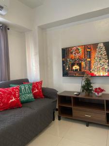a living room with a couch and a christmas tree at The Penthouse Suite in Pusok