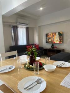 a wooden table with plates and utensils on it at The Penthouse Suite in Pusok