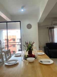a dining room table with a vase of flowers on it at The Penthouse Suite in Pusok