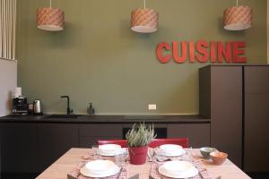 a table with chairs and a sign that reads cuisine at Terra e Lago - Holiday home in Roe +15 photos