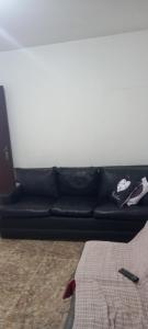 贝洛奥里藏特Casa aconchegante的客厅里一张黑色沙发