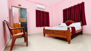 a bedroom with a bed and a chair at 10 mins to Rock Beach-Sérénade Homestay in Puducherry