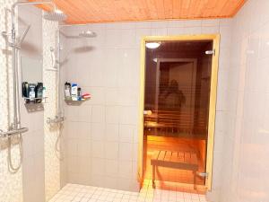 a bathroom with a shower with a bench in it at Stylish and Spacious House in Vantaa in Vantaa