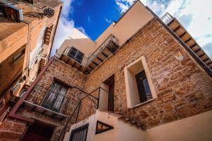 a brick building with a balcony on the side of it at Casa Lerux in Agrigento