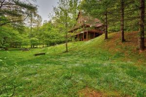 a house on top of a hill in the woods at Hidden Creek Cabin in Fleetwood