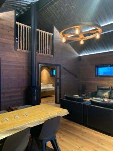 a living room with a wooden table and a couch at Villa Hulu in Broaryd +24 photos