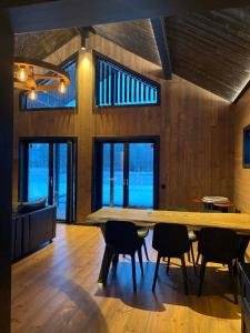 a dining room with a large wooden table and chairs at Villa Hulu in Broaryd