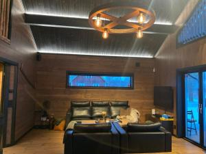 a living room with a couch and a ceiling at Villa Hulu in Broaryd