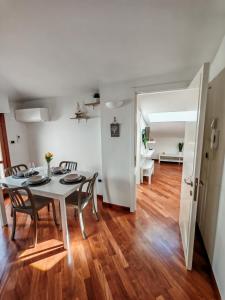 a dining room and living room with a table and chairs at Gioia's House in Montesilvano