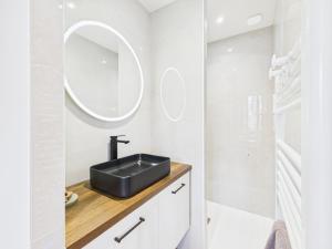 a bathroom with a sink and a mirror at La petite suite Ponote in Le Puy en Velay