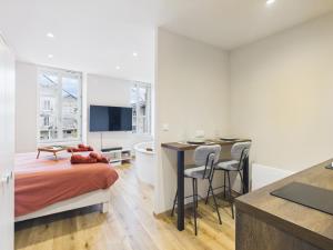 a bedroom with a bed and a desk and a bathroom at La petite suite Ponote in Le Puy en Velay +2 photos