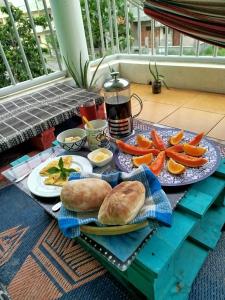 a table with plates of bread and carrots on it at Kasa Sirena in Tarrafal