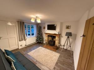 a living room with a fireplace and a christmas tree at Two bedroom house in eye Suffolk with parking in Eye