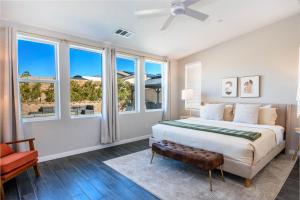 a white bedroom with a large bed and windows at #Marbella Lane - Desert Dream Pool Spa & Games in Desert Hot Springs +54 photos