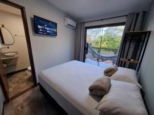 Ένα ή περισσότερα κρεβάτια σε δωμάτιο στο Casas Pipa Brasil