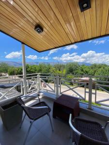 a balcony with chairs and a table and a view at Alto Valle in Nono +44 photos