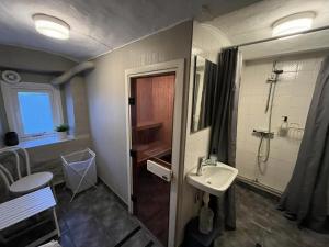 a bathroom with a sink and a shower at Hotell Strandvillan Orsa in Orsa +62 photos