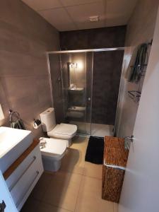 a small bathroom with a toilet and a shower at Apartment with terrace in Vinarós