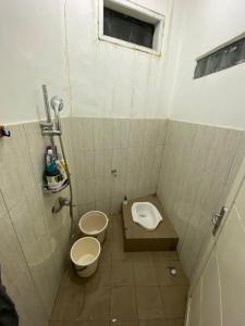 a small bathroom with a toilet and a sink at Villa Pangalengan in Palayangan
