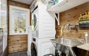 a kitchen with a washing machine and a sink at Family Cabin With Jacuzzi At Tempelseter in Eggedal +26 photos