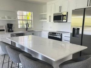 a kitchen with a white counter top and appliances at Tropical Bliss in George Town