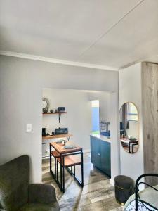 a living room with a table and a kitchen at Walnut Studio in Clarens