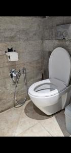 a bathroom with a toilet and a roll of toilet paper at Le Havre de Paix in Nabeul +9 photos