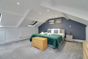 a bedroom with a bed in a attic at Penthouse Parade Apartment, Sleeps 6 in Harrogate