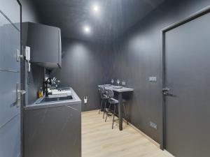a kitchen with a sink and a counter with a table at Cinquante Nuances Ponotes in Le Puy-en-Velay