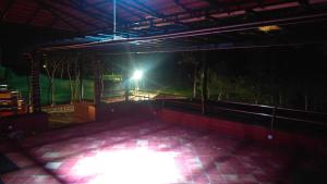 a dark room with a light in the middle at Blue Nile Homestay Kotagiri in Kotagiri