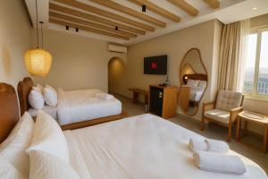 Ένα ή περισσότερα κρεβάτια σε δωμάτιο στο ONE GATE Pyramids View INN