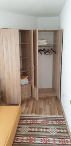 a room with wooden cabinets and a rug at Daily rental apartment Travnik in Travnik