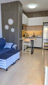 a kitchen with a bed and a table in a room at Apartamento Cabo de Palos - La Manga con Aire Acondicionado in Cartagena