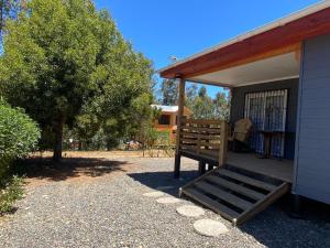 a porch of a house with a bench on it at Casa Pichilemu in Pichilemu