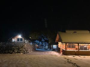 a house in the snow at night at Laki house in Jasień