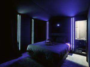 a dark room with a bed with lights on it at Ciné-Ponot in Le Puy en Velay