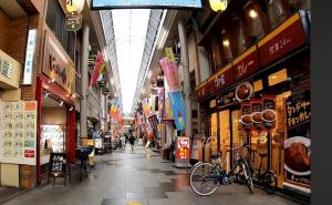 an aisle of a shopping mall with a bike in the middle at Good One Awaji Accessia 401 in Osaka